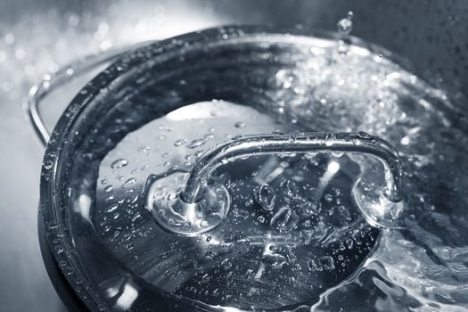 Steel lid from the pan with water drops