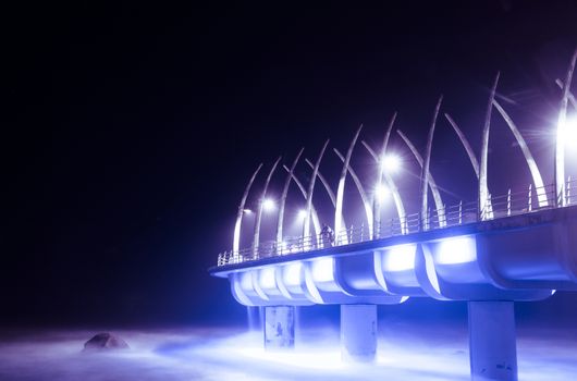 durban pier in umhlanga at night surrounded by lights over the ocean