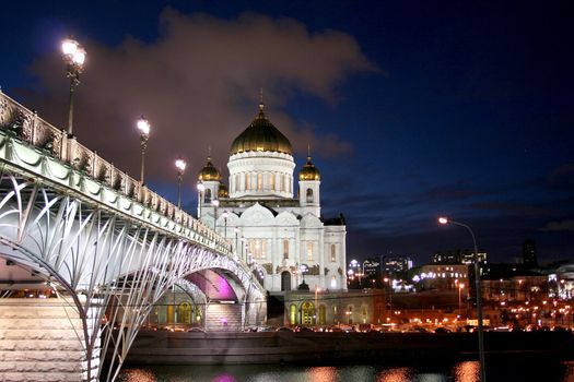 Night landscape the bridge through the Moskva River and the Cathedral of Christ the Saviour in the city of Moscow