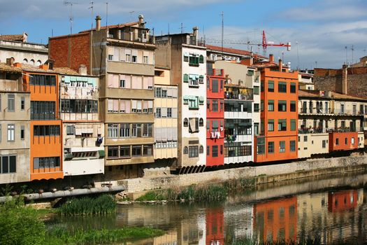 Typical view of girona in catalonia the river onyar and the different painted buildings in front of it