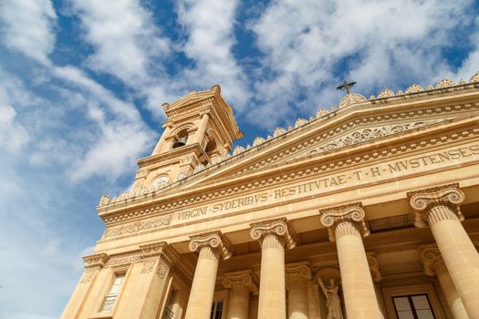 MOSTA, MALTA - NOVEMBER 1, 2015 : Exterior view of Rotunda of Malta known as also Mosta Dome, historical and the third biggest church in Europe, on cloudy blue sky background.