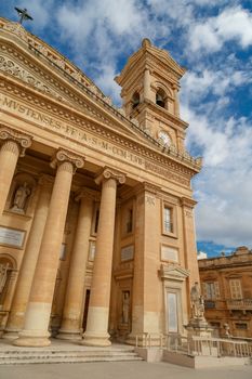 MOSTA, MALTA - NOVEMBER 1, 2015 : Exterior view of Rotunda of Malta known as also Mosta Dome, historical and the third biggest church in Europe, on cloudy blue sky background.
