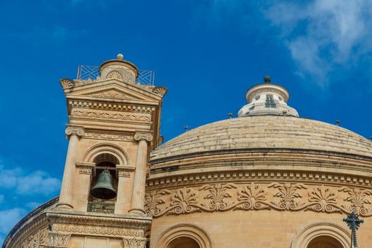 MOSTA, MALTA - NOVEMBER 1, 2015 : Exterior view of Rotunda of Malta known as also Mosta Dome, historical and the third biggest church in Europe, on cloudy blue sky background.