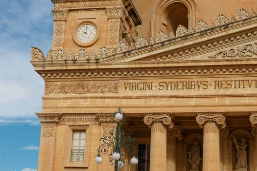 MOSTA, MALTA - NOVEMBER 1, 2015 : Exterior view of Rotunda of Malta known as also Mosta Dome, historical and the third biggest church in Europe, on cloudy blue sky background.