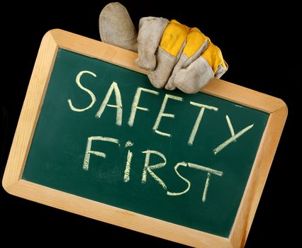 worker holding a board with the inscription SAFETY FIRST