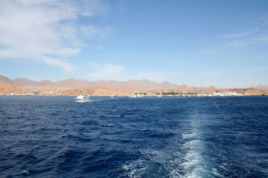 Sea landscape in the Red Sea against small mountains of the Sinai Peninsula