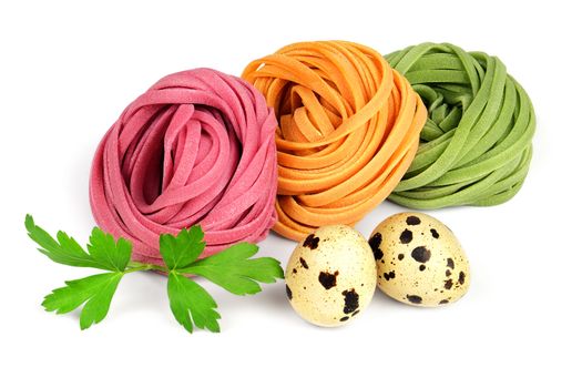 Italian colored fresh rolled fettuccine pasta with quail eggs and parsley isolated on white background.