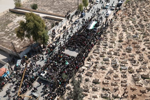 SYRIA, Saqba: Protesters hold pre-Baath Syrian flags, adopted during the uprising in 2011, and placards during an anti-regime demonstration along cemetery of the rebel-held town of Saqba, on the outskirts of the Syrian capital Damascus, on March 18, 2016. Syria's war is entering its sixth year with a glimmer of hope that a landmark ceasefire and a push for peace could help resolve a conflict that has sent hundreds of thousands fleeing to Europe. The conflict began with anti-regime protests in mid-March 2011 and spiralled into a bloody war after a harsh government crackdown on demonstrators.