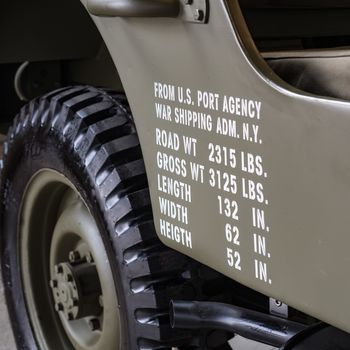 Dimensions and weights printed on the side of a military off road used in World War II.