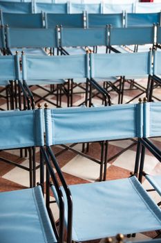 composition of blue canvas folding chairs empty