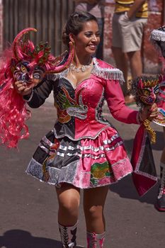 Young woman performing the Diablada (dance of the devil) as part of the Carnaval Andino con la Fuerza del Sol in Arica, Chile. The dance originates in Oruro, Bolivia.