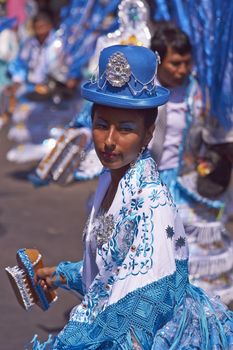 Female dancer in a Morenada dance group performing a traditional ritual dance as part of the Carnaval Andino con la Fuerza del Sol in Arica, Chile.