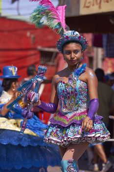 Female dancer in a Morenada dance group performing a traditional ritual dance as part of the Carnaval Andino con la Fuerza del Sol in Arica, Chile.