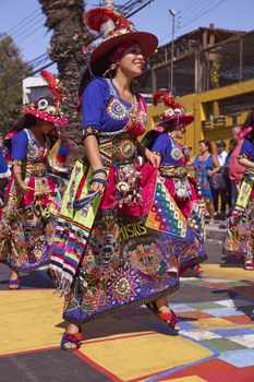 Tinku dancing group in colourful costumes performing a traditional ritual dance as part of the Carnaval Andino con la Fuerza del Sol in Arica, Chile.