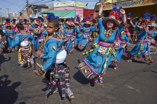 Tinku dancing group in colourful costumes performing a traditional ritual dance as part of the Carnaval Andino con la Fuerza del Sol in Arica, Chile.