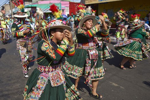 Tinku dancing group in colourful costumes performing a traditional ritual dance as part of the Carnaval Andino con la Fuerza del Sol in Arica, Chile.