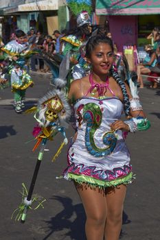 Young woman performing in a Tobas dance group at the Carnaval Andino con la Fuerza del Sol in Arica, Chile. The dance originates in Oruro, Bolivia.