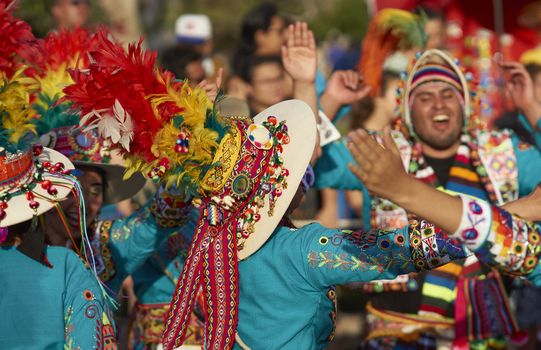 Tinku dancing group in colourful costumes performing a traditional ritual dance as part of the Carnaval Andino con la Fuerza del Sol in Arica, Chile.