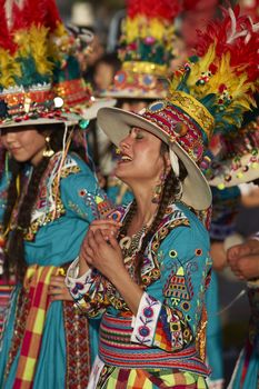 Tinku dancer in colourful costume singing whilst performing a traditional ritual dance as part of the Carnaval Andino con la Fuerza del Sol in Arica, Chile.