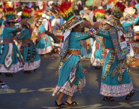 Tinku dancing group in colourful costumes performing a traditional ritual dance as part of the Carnaval Andino con la Fuerza del Sol in Arica, Chile.