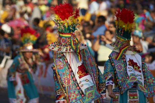Tinku dancing group in colourful costumes performing a traditional ritual dance as part of the Carnaval Andino con la Fuerza del Sol in Arica, Chile.