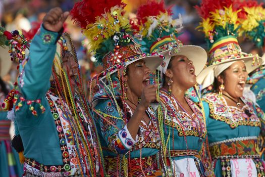 Tinku dancing group in colourful costumes performing a traditional ritual dance as part of the Carnaval Andino con la Fuerza del Sol in Arica, Chile.