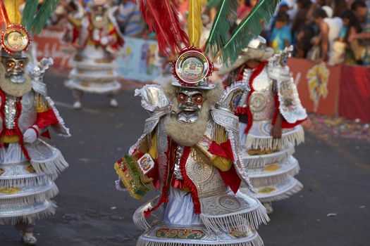 Morenada dance group in traditional Andean costumes performing at the annual Carnaval Andino con la Fuerza del Sol in Arica, Chile.