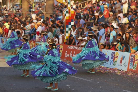 Morenada dance group in traditional Andean costumes performing at the annual Carnaval Andino con la Fuerza del Sol in Arica, Chile.