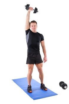 Young man shows finishing position of Standing Triceps Extension Dumbbell  behind head workout, isolated on white