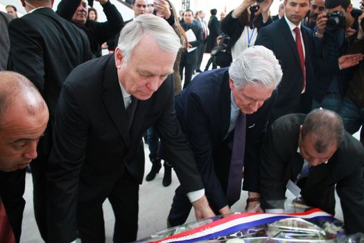 TUNISIA, Tunis: French Foreign Minister Jean-Marc Ayrault helps unveil a memorial at Bardo National Museum on March 18, 2016 for the one-year-anniversary of the terror attack there. The assault by Islamic State militants left 24 people dead that day in 2015.