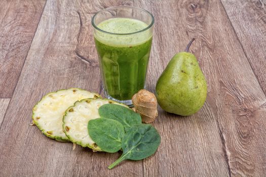 Blended fruit smoothie with ingredients on wooden table