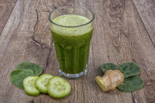 Blended fruit smoothie with ingredients on wooden table
