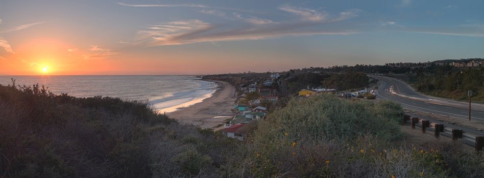 Cottages along Crystal Cove Beach, on the Newport Beach and Laguna Beach line in Southern California at sunset with a rainstorm looming.