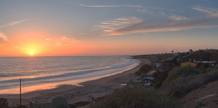 Cottages along Crystal Cove Beach, on the Newport Beach and Laguna Beach line in Southern California at sunset with a rainstorm looming.