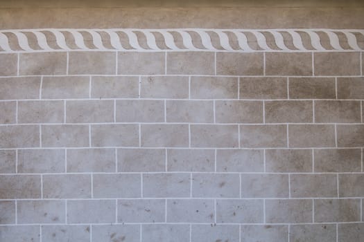 Grey-brown wall, original color of the facade and concrete, with contrast white texture and pattern in renaissance style.