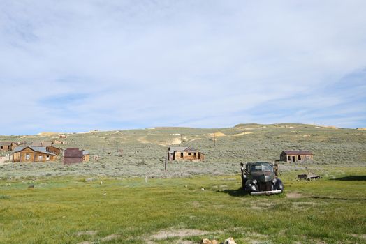 an old car in Bodie historic state park of a ghost town from a gold rush era in Sierra Nevada