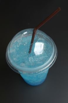Blue cocktail in a plastic cup
