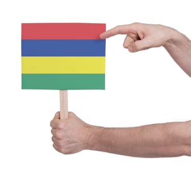 Hand holding small card, isolated on white - Flag of Mauritius