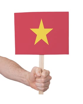 Hand holding small card, isolated on white - Flag of Vietnam