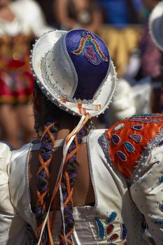 Caporales dancer in ornate blue and white costumes performing at the annual Carnaval Andino con la Fuerza del Sol in Arica, Chile.