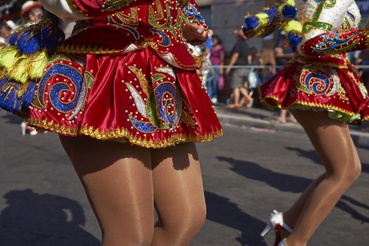 Detail of the ornate skirts worn by the female members of a Caporales dance group performing at the annual Carnaval Andino con la Fuerza del Sol in Arica, Chile.