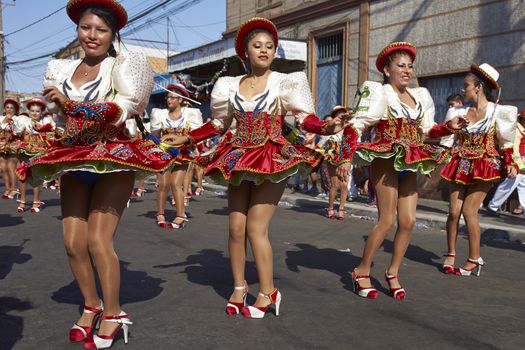 Caporales dancers in ornate costumes performing at the annual Carnaval Andino con la Fuerza del Sol in Arica, Chile.