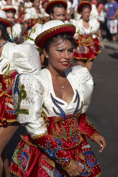 Caporales dancers in ornate costumes performing at the annual Carnaval Andino con la Fuerza del Sol in Arica, Chile.