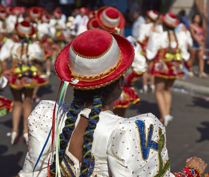 Caporales dancers in ornate costumes performing at the annual Carnaval Andino con la Fuerza del Sol in Arica, Chile.