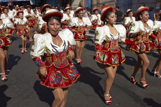 Caporales dancers in ornate costumes performing at the annual Carnaval Andino con la Fuerza del Sol in Arica, Chile.