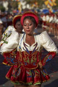 Caporales dancers in ornate costumes performing at the annual Carnaval Andino con la Fuerza del Sol in Arica, Chile.