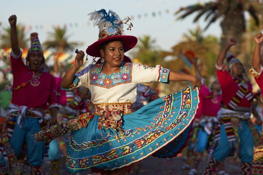 Tinku dancing group in colourful costumes performing a traditional ritual dance as part of the Carnaval Andino con la Fuerza del Sol in Arica, Chile.