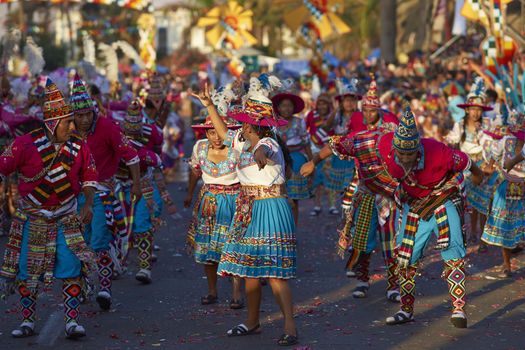 Tinku dancing group in colourful costumes performing a traditional ritual dance as part of the Carnaval Andino con la Fuerza del Sol in Arica, Chile.