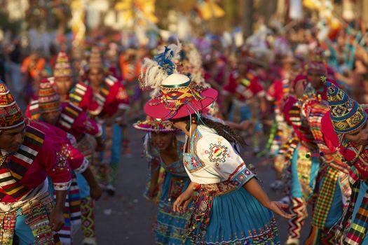 Tinku dancing group in colourful costumes performing a traditional ritual dance as part of the Carnaval Andino con la Fuerza del Sol in Arica, Chile.