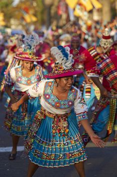 Tinku dancing group in colourful costumes performing a traditional ritual dance as part of the Carnaval Andino con la Fuerza del Sol in Arica, Chile.